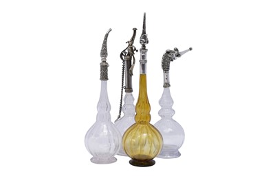 Lot 192 - AN IMPRESSIVE GROUP OF ELEVEN MUGHAL MOULD-BLOWN GLASS ROSEWATER SPRINKLERS WITH SILVER MOUNTS