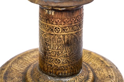 Lot 365 - AN IMPRESSIVE LARGE MAMLUK ENGRAVED BRASS CANDLESTICK WITH THE SCRIBE INSIGNIA