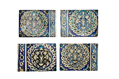 Lot 397 - FOUR OTTOMAN DAMASCUS POTTERY BORDER TILES WITH FLOWERING VASES