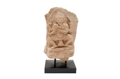Lot 102 - A SMALL CARVED SANDSTONE STELE WITH FOUR-ARMED GANESHA