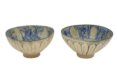 Lot 20 - TWO SULTANABAD POTTERY BOWLS WITH CALLIGRAPHY AND VEGETAL MOTIFS