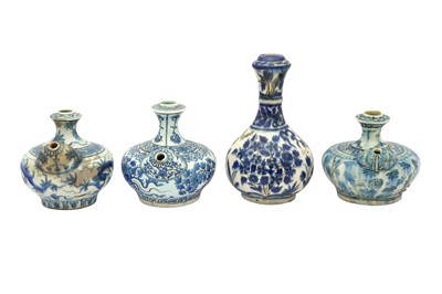 Lot 30 - THREE ASIAN-INSPIRED KENDI BLUE AND WHITE POTTERY QALYAN BOTTLES AND A VASE