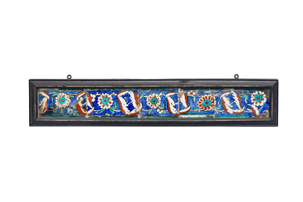 Lot 398 - AN IZNIK POTTERY BORDER TILE PANEL