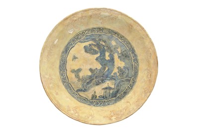 Lot 71 - A LARGE ASIAN-INSPIRED BLUE AND WHITE POTTERY CHARGER WITH CHINESE LANDSCAPE