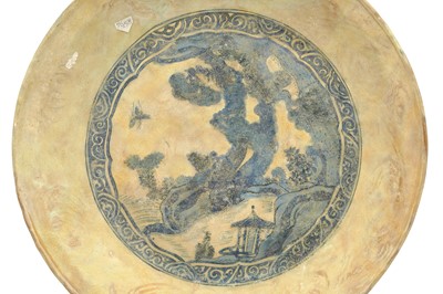 Lot 71 - A LARGE ASIAN-INSPIRED BLUE AND WHITE POTTERY CHARGER WITH CHINESE LANDSCAPE