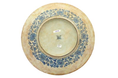 Lot 71 - A LARGE ASIAN-INSPIRED BLUE AND WHITE POTTERY CHARGER WITH CHINESE LANDSCAPE