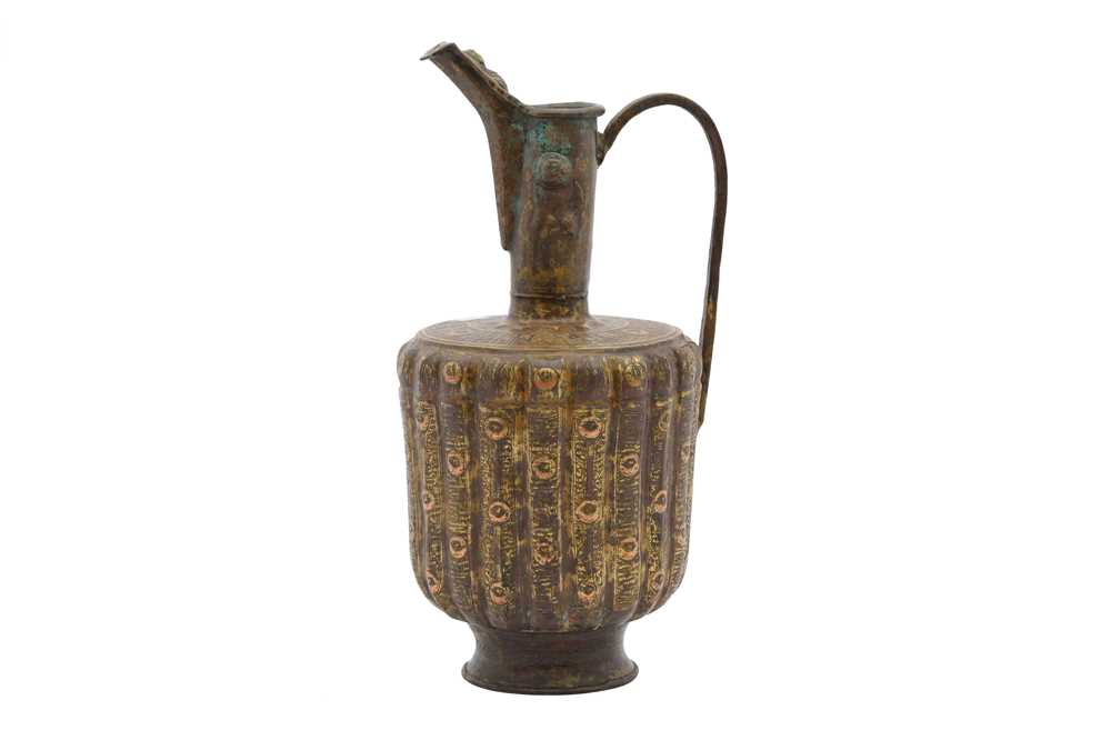Lot 9 - A COPPER-INLAID BRASS EWER WITH LION AND LUNAR MOTIFS