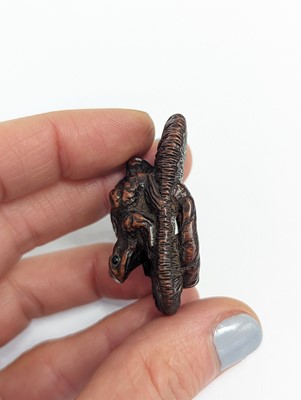 Lot 1021 - A JAPANESE WOOD NETSUKE OF A TOAD ON A SLIPPER