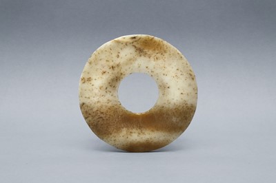 Lot 360 - A SMALL CHINESE ARCHAIC MOTTLED JADE DISC, BI