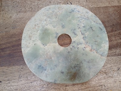 Lot 322 - A LARGE CHINESE ARCHAIC GREEN JADE DISC, BI