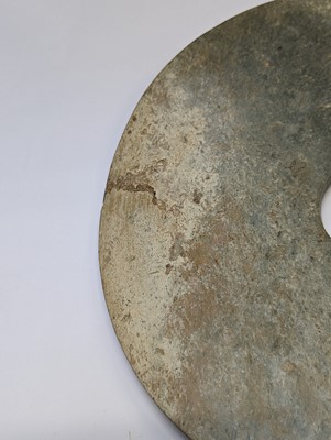 Lot 374 - A LARGE CHINESE ARCHAIC MOTTLED GREEN JADE DISC, BI
