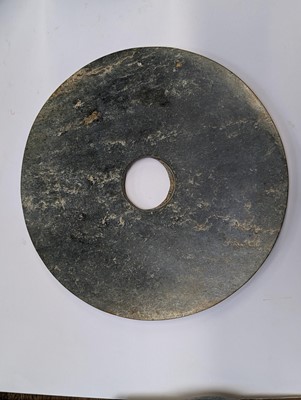 Lot 374 - A LARGE CHINESE ARCHAIC MOTTLED GREEN JADE DISC, BI
