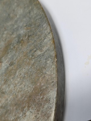 Lot 374 - A LARGE CHINESE ARCHAIC MOTTLED GREEN JADE DISC, BI