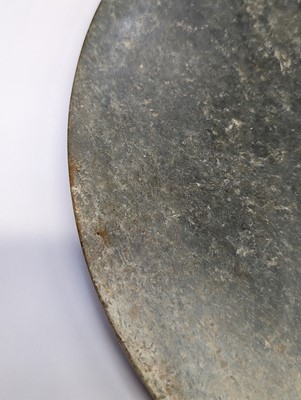 Lot 374 - A LARGE CHINESE ARCHAIC MOTTLED GREEN JADE DISC, BI