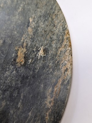 Lot 374 - A LARGE CHINESE ARCHAIC MOTTLED GREEN JADE DISC, BI