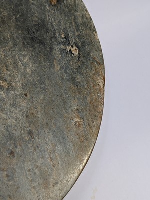 Lot 374 - A LARGE CHINESE ARCHAIC MOTTLED GREEN JADE DISC, BI
