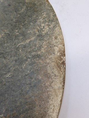 Lot 374 - A LARGE CHINESE ARCHAIC MOTTLED GREEN JADE DISC, BI