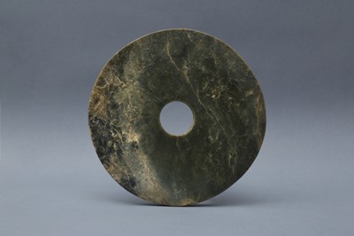Lot 373 - A LARGE CHINESE ARCHAIC MOTTLED GREEN JADE DISC, BI