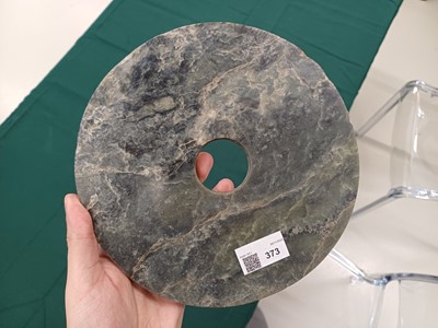 Lot 373 - A LARGE CHINESE ARCHAIC MOTTLED GREEN JADE DISC, BI