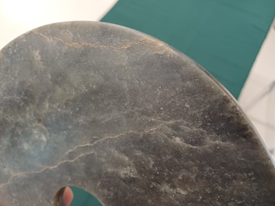 Lot 373 - A LARGE CHINESE ARCHAIC MOTTLED GREEN JADE DISC, BI