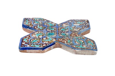 Lot 276 - A COBALT BLUE AND COPPER LUSTRE-PAINTED POTTERY CROSS-SHAPED TILE