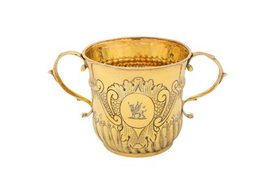 Lot 462 - A Queen Anne Britannia standard silver gilt twin handled porringer, London 1712 by Timothy Ley (reg. April 1697)