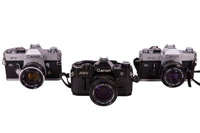 Lot 1137 - Three Canon SLR Cameras, inc AE-1 with f1.4 Lens.