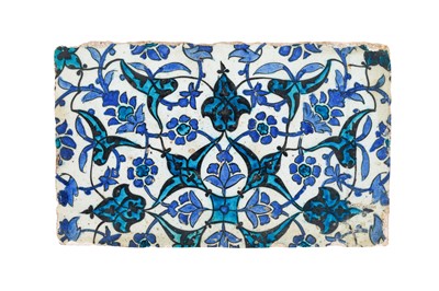 Lot 395 - A FRAGMENT OF A LARGE TURQUOISE, COBALT BLUE, AND BLACK-PAINTED 'DOME OF THE ROCK' POTTERY TILE