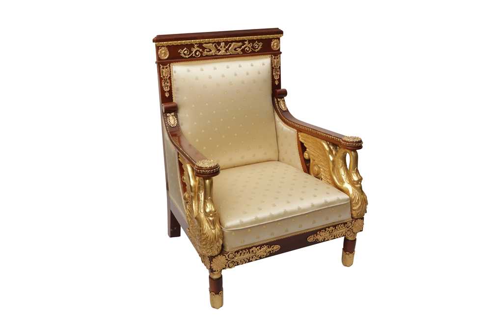 Lot 101 - A FRENCH EMPIRE STYLE PARCEL GILT MAHOGANY ARMCHAIR