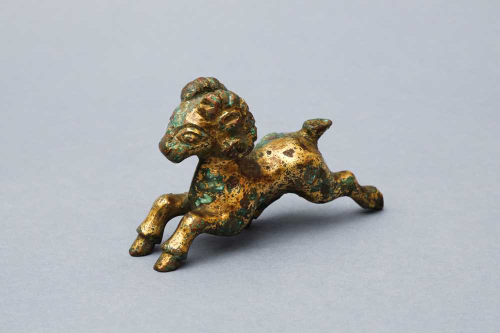 Lot 318 - A CHINESE GILT-BRONZE MODEL OF A RAM