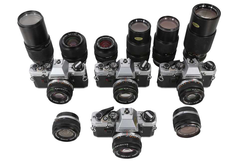 Lot 370 - Four Olympus OM10 Outfits, Comprising 4 Bodies & 12 OM Lenses.