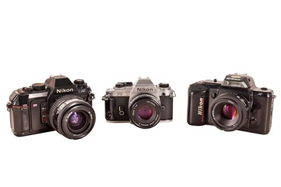 Lot 1142 - Three Nikon SLR cameras.