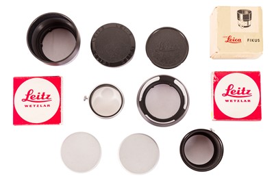 Lot 1140 - Three Leica lenshoods and accessories.