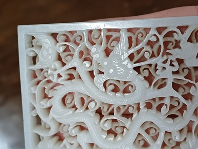 Lot 120 - A CHINESE WHITE JADE RETICULATED 'DRAGON' PLAQUE