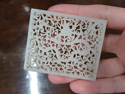 Lot 120 - A CHINESE WHITE JADE RETICULATED 'DRAGON' PLAQUE