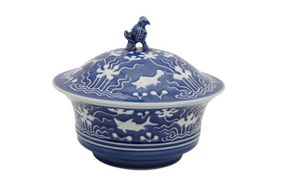 Lot 632 - A CHINESE SLIP-DECORATED BLUE-GROUND 'FISH' POT AND COVER