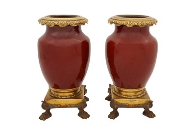 Lot 50 - A PAIR OF SANG DE BOUEF MOUNTED VASES