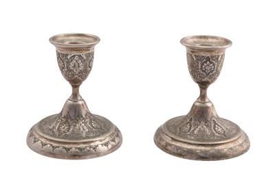 Lot 233 - A pair of mid-20th century Iranian (Persian) unmarked silver dwarf candlesticks, Isfahan circa 1960