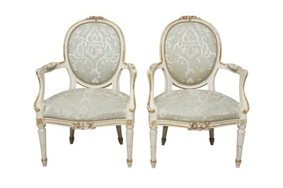 Lot 780 - A PAIR OF FRENCH LOUIS XVI STYLE WHITE PAINTED AND PARCEL GILT FAUTEUIL ARMCHAIRS