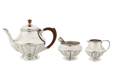 Lot 307 - A George V ‘Arts and Crafts’ sterling silver three-piece tea service, Birmingham 1927 by William Hair Haseler for Liberty