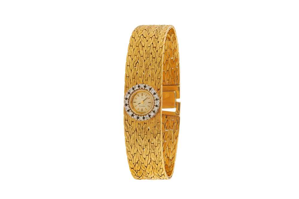 Lot 212 - OMEGA - AN 18K GOLD AND DIAMOND-SET BRACELET WATCH