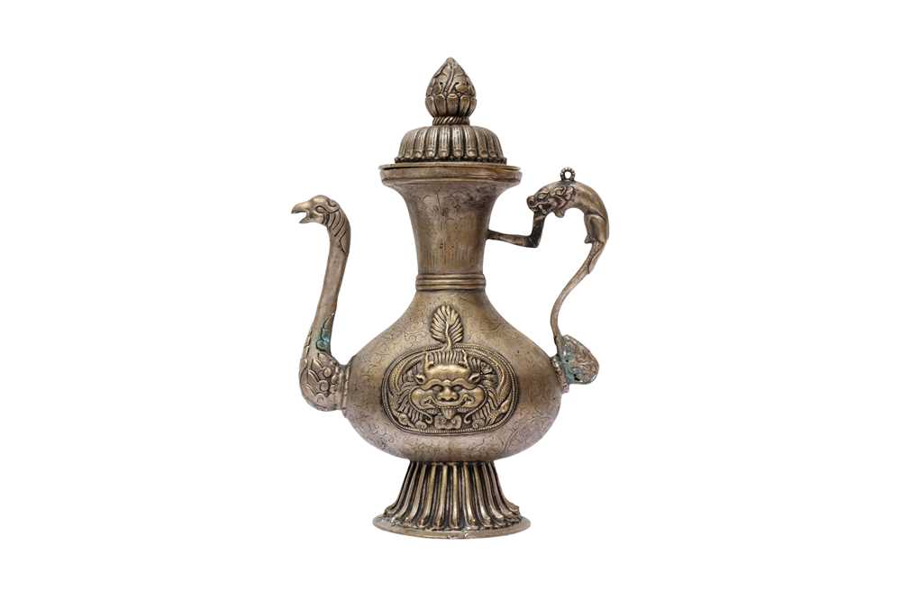 Lot 348 - A TIBETAN BRONZE EWER AND COVER