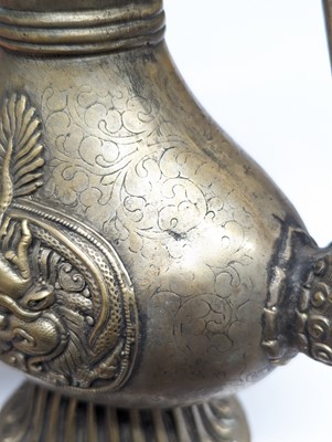 Lot 348 - A TIBETAN BRONZE EWER AND COVER