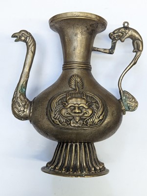 Lot 348 - A TIBETAN BRONZE EWER AND COVER