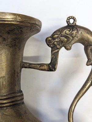 Lot 348 - A TIBETAN BRONZE EWER AND COVER