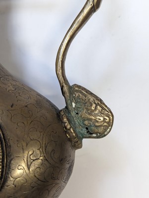 Lot 348 - A TIBETAN BRONZE EWER AND COVER