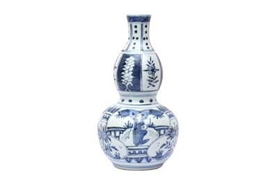 Lot 528 - A CHINESE MING-STYLE BLUE AND WHITE DOUBLE GOURD VASE