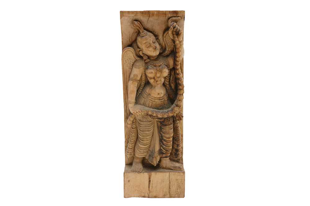 Lot 335 A CARVED WOODEN WALL HANGING STATUE OF A