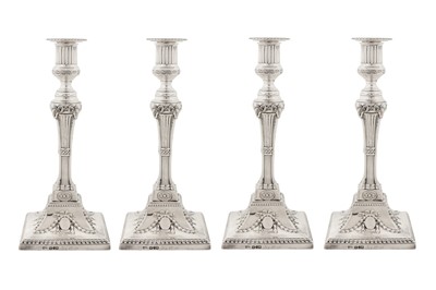 Lot 450 - A set of four George III sterling silver candlesticks, Sheffield overstruck for London 1774 by John Carter II