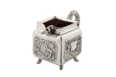 Lot 187 - An early 20th century Chinese export silver three-piece tea service, Canton circa 1920 by Qiao Zhen, retailed by Cum Wo of Hong Kong